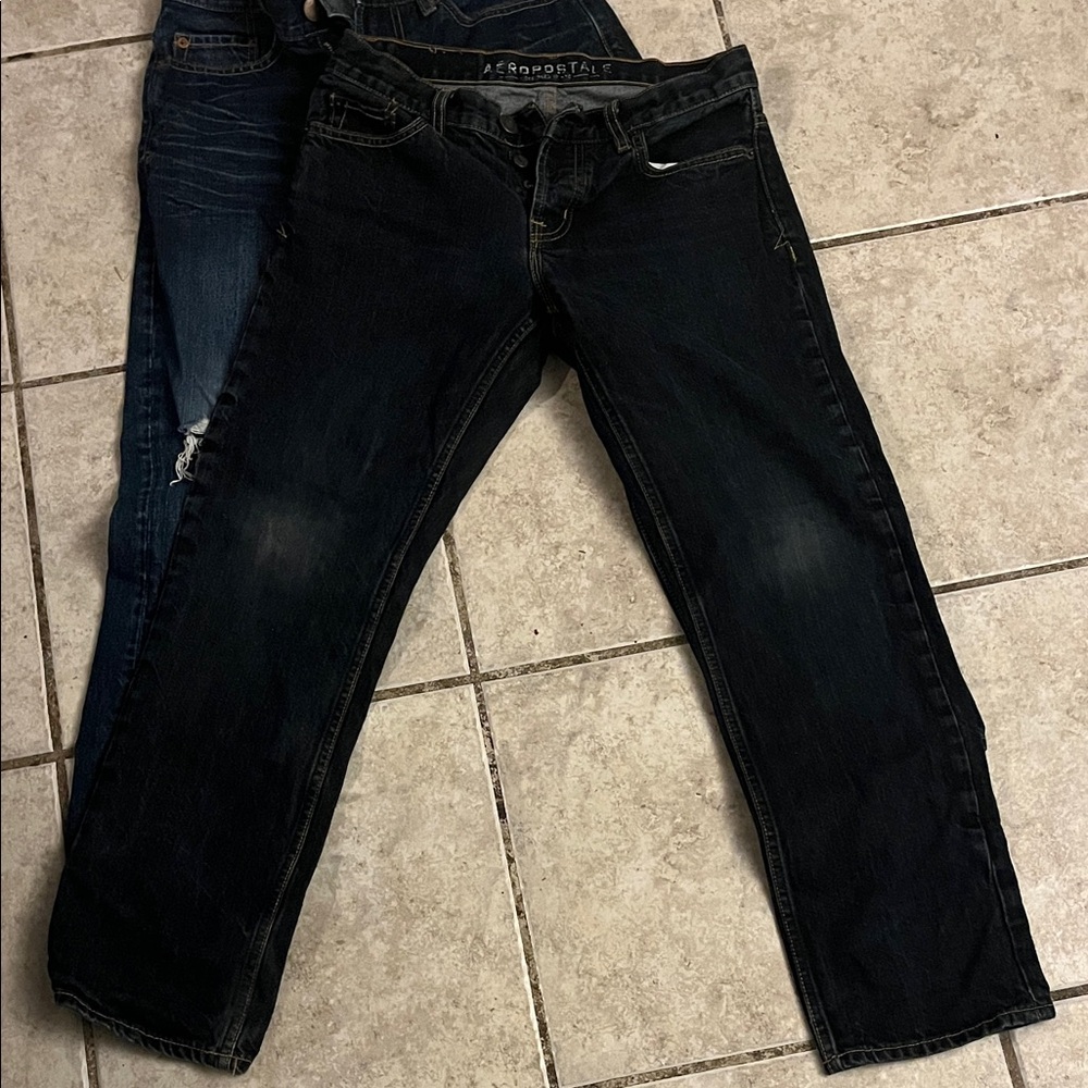 2 pairs Jeans faded wash and dark blue one zip up other button up